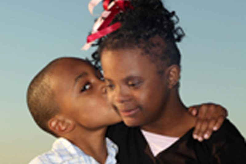 Brother giving sister a hug and kiss. Page 25