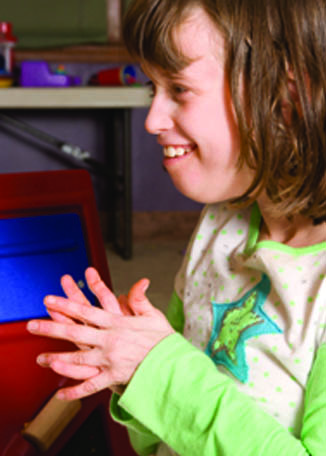 Child smiling with her hands together. Page 36