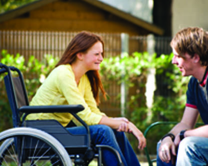 Woman in a wheelchair interacting with an adult. Page 37