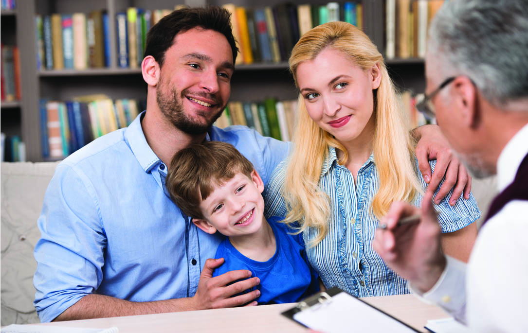 boy and parents at a meeting