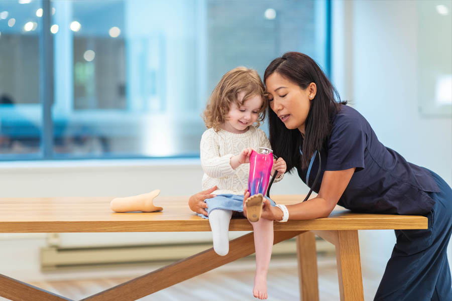 Mom with daughter who is missing part of a leg.