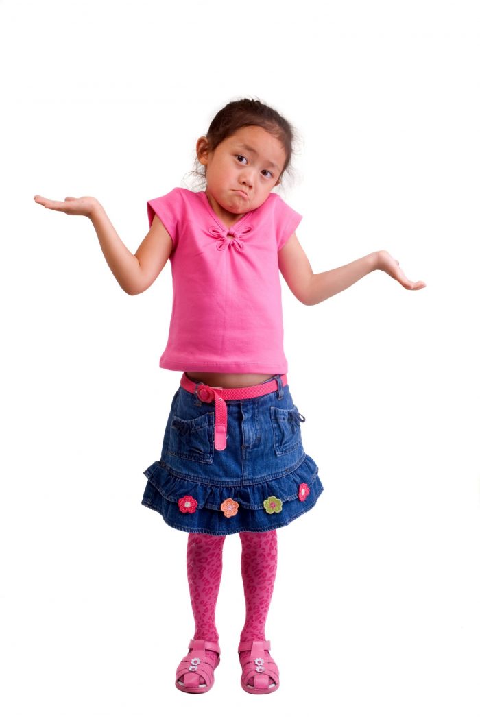 Young girl shrugging shoulders.