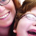 Mother and young daughter laughing