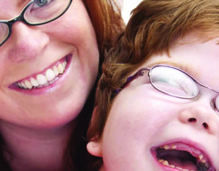 Mother and young daughter laughing