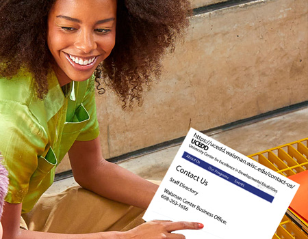 Young girl pointing to her computer showing UCEDD website