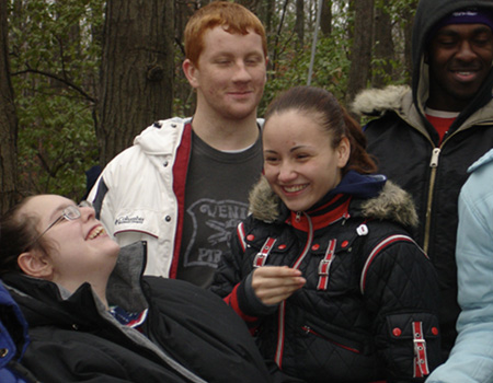 Youth gathered around young girl in wheelchair
