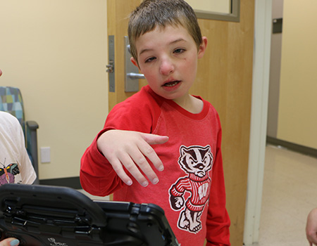 Boy using AAC device