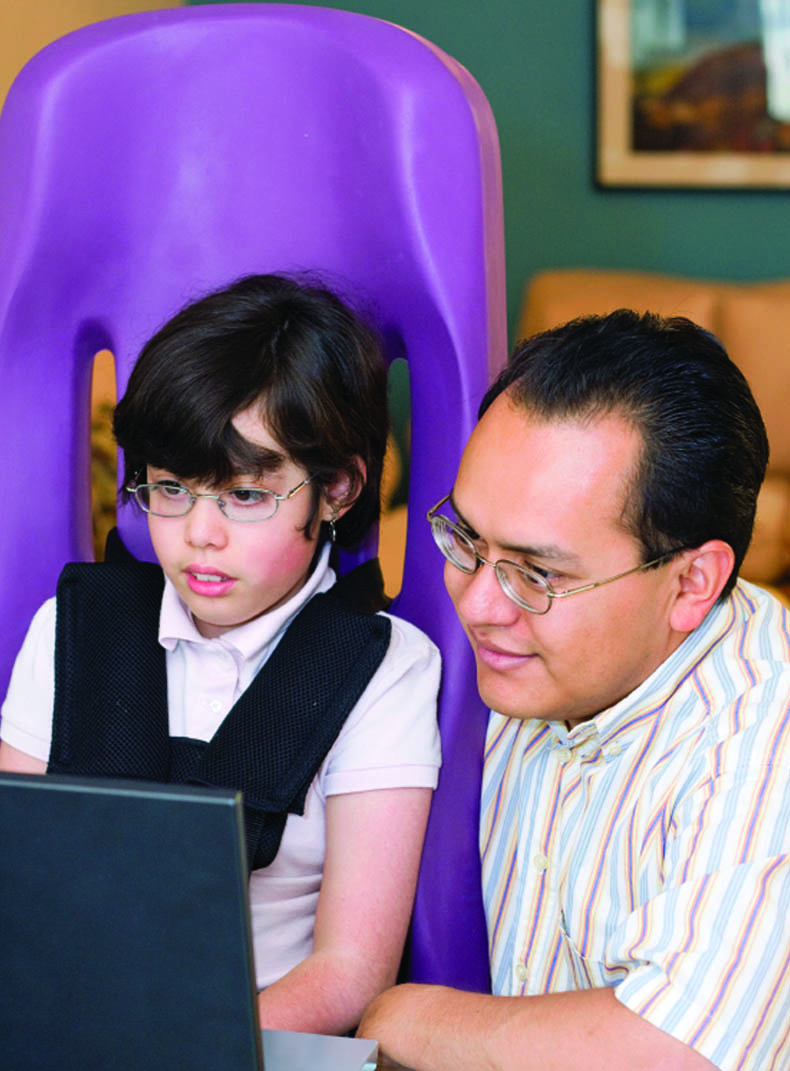 Father and son in front of computer